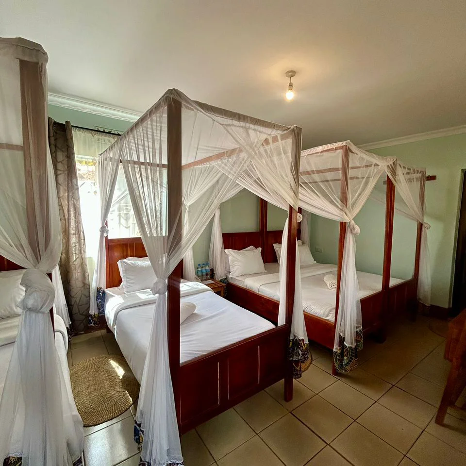 Triple suite with multiple beds arranged for a group stay.